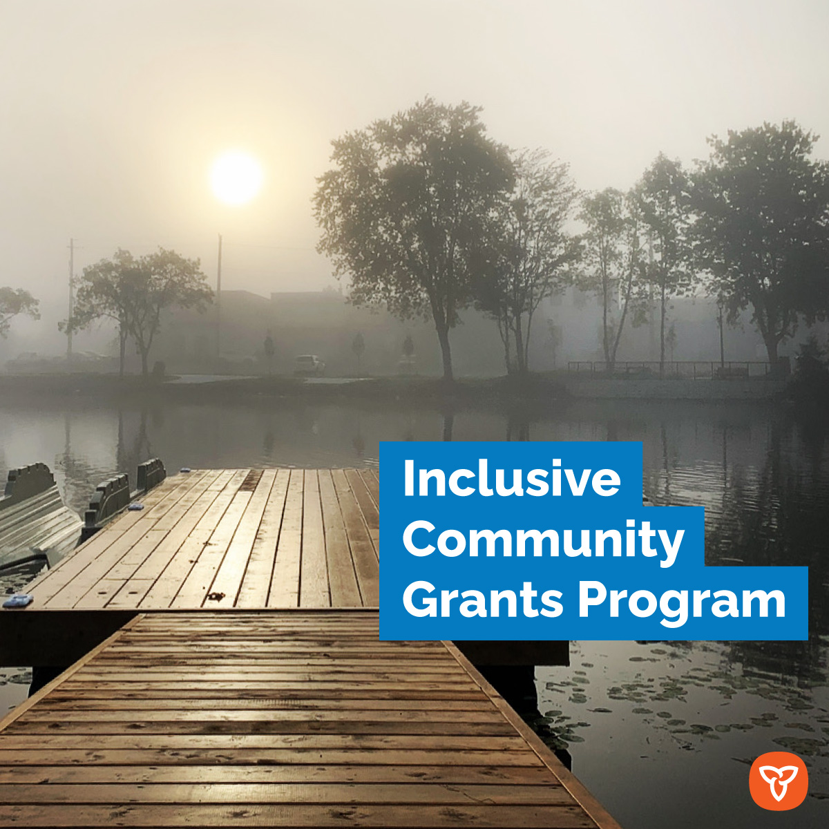 Photo of a dock on the water on a foggy morning. Text reads 'Inclusive Community Grants'