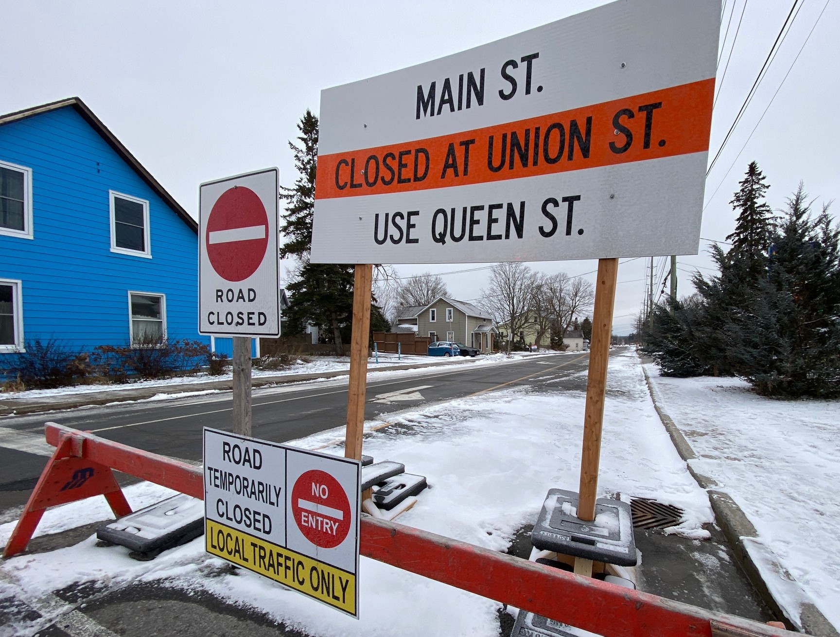 Image of a road closure with orange and white signage