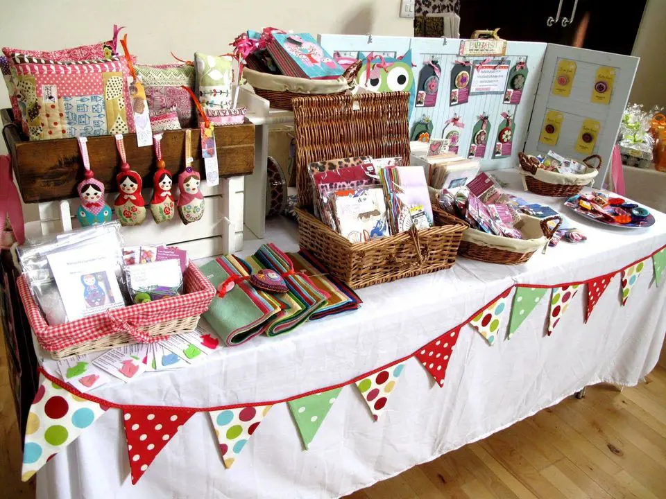 Photo of table decorated with merchandise at a craft fair
