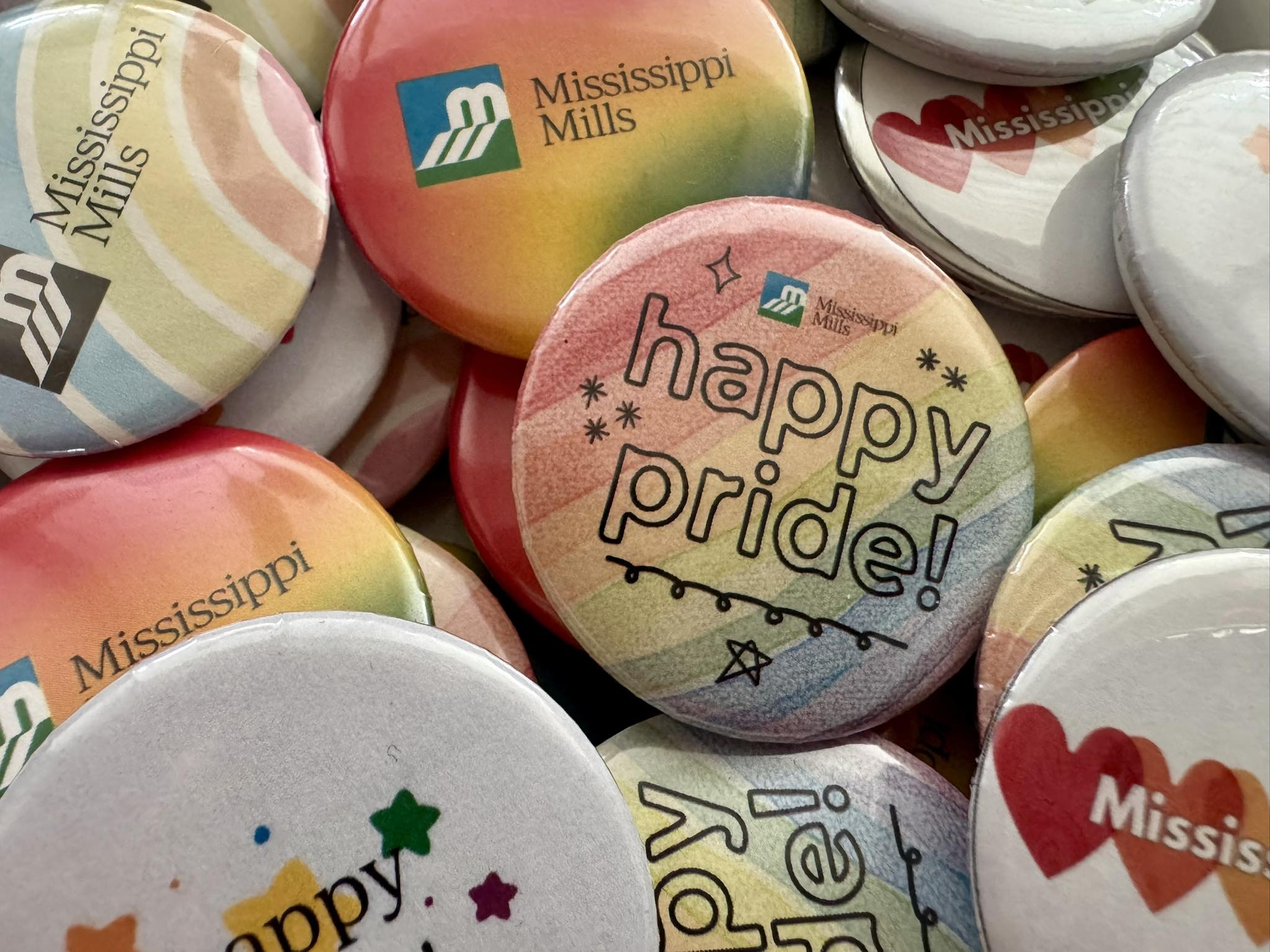 Closeup photo of colourful Pride Month buttons