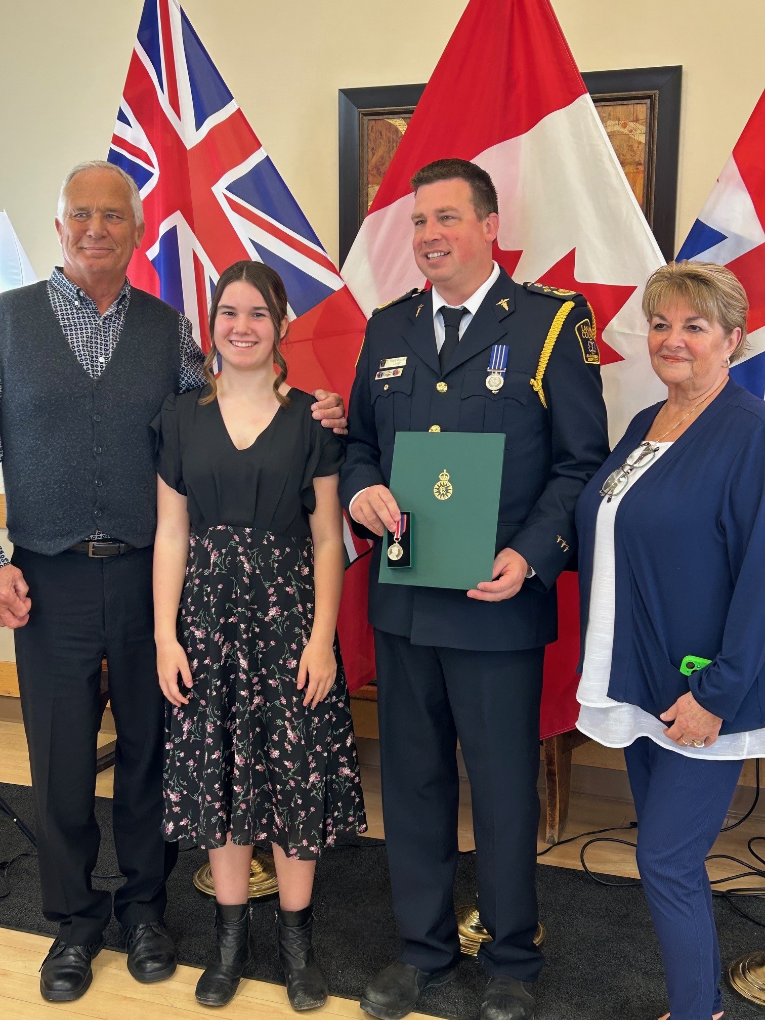 Photo of four people standing together for award recognition