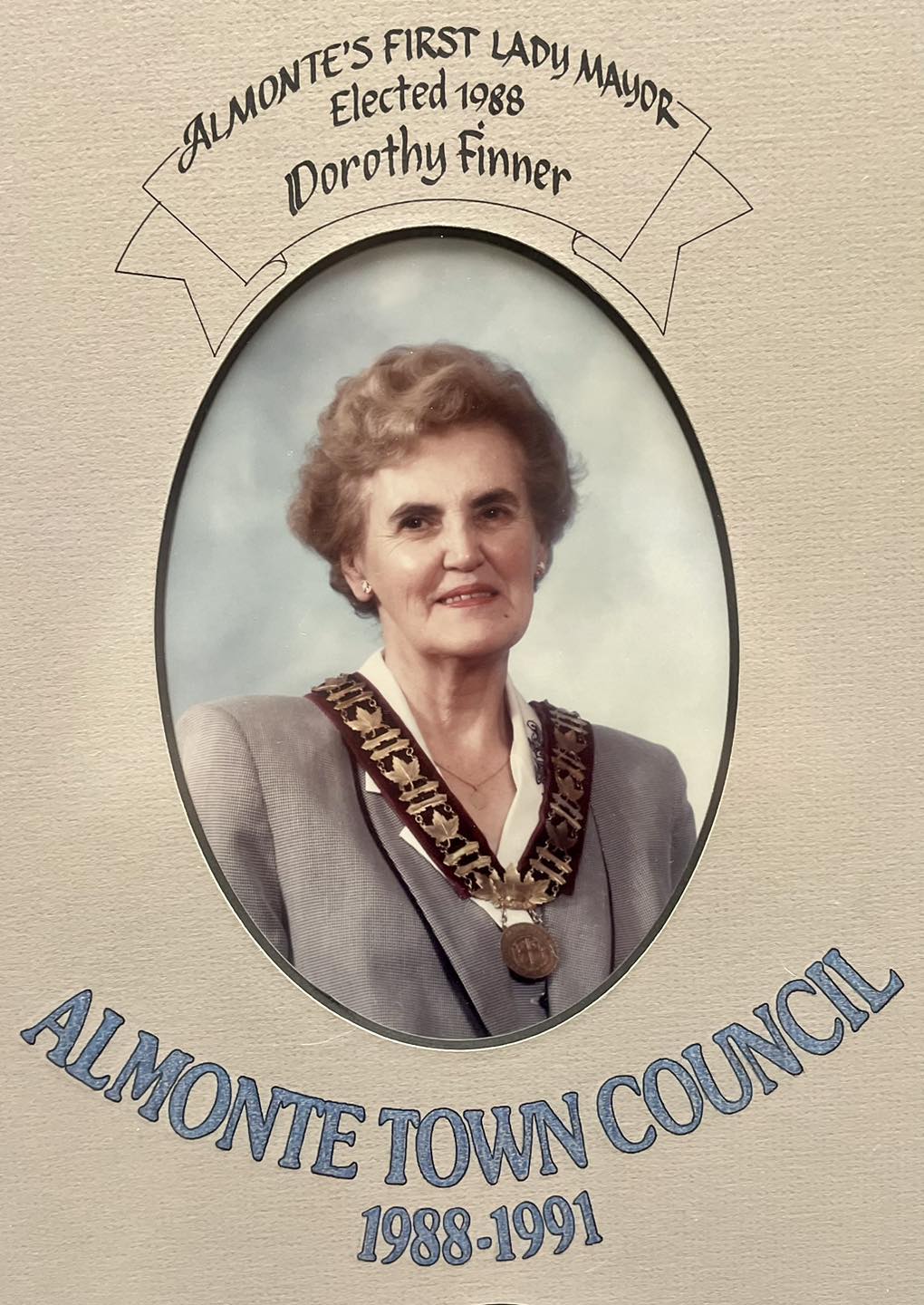 Photo of a woman in a grey jacket with chains of office and text 'Almonte's First Lady Mayor Elected 1988 Dorothy Finner'