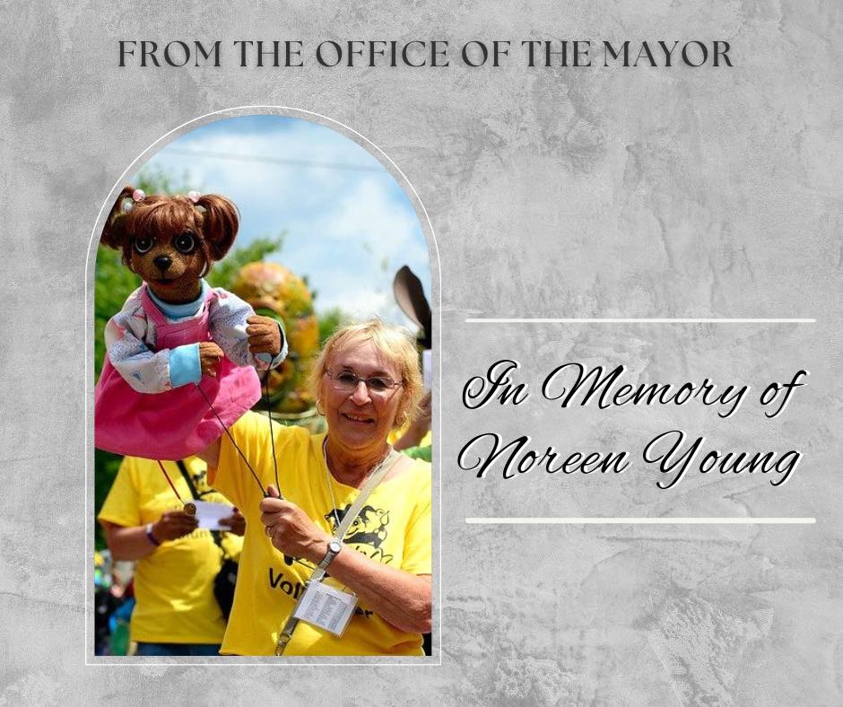 Graphic with photo of woman holding up a puppet and the text 'From the Office of the Mayor - In Memory of Noreen Young'