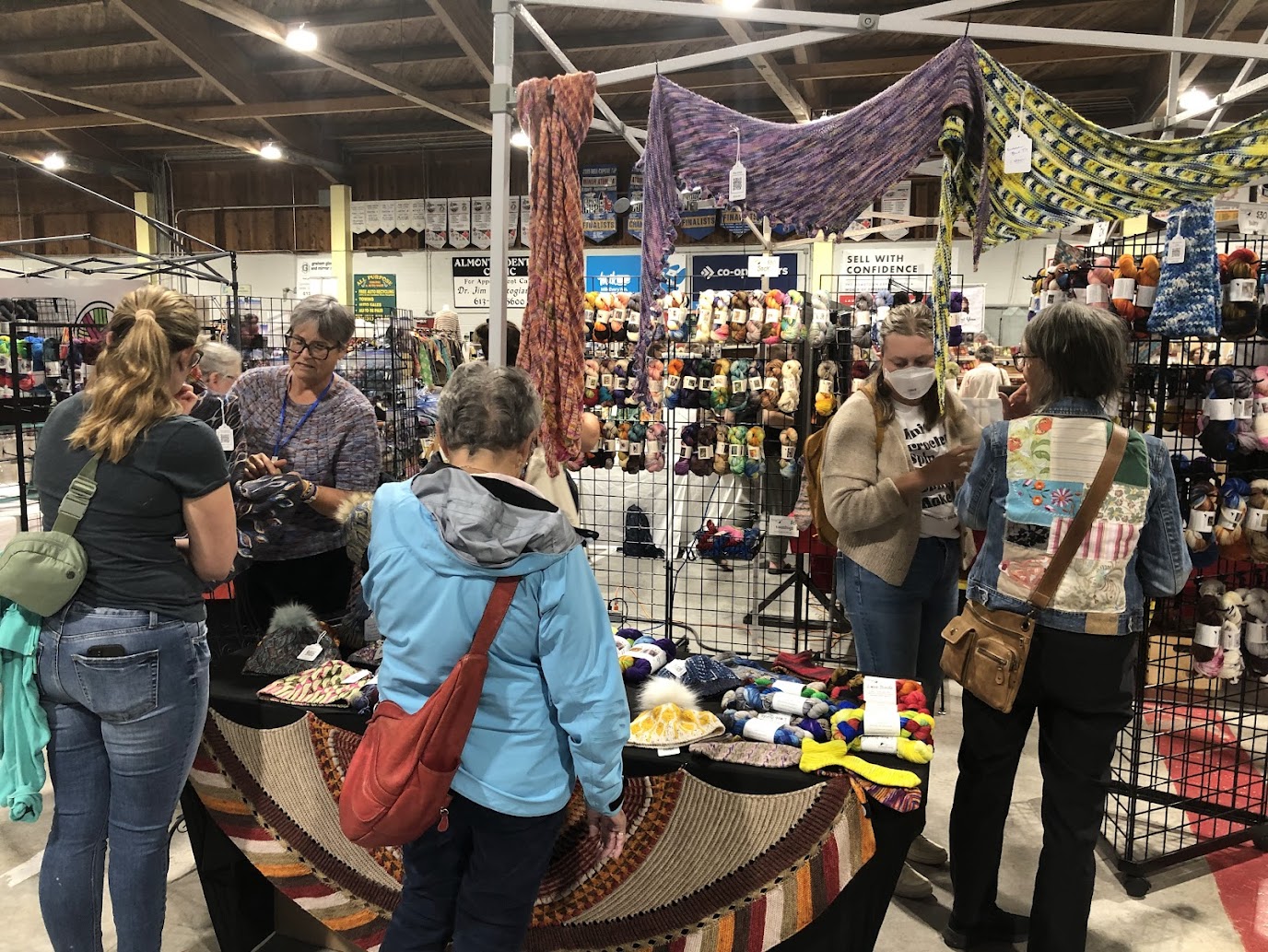 Photo of people looking at booths with textiles