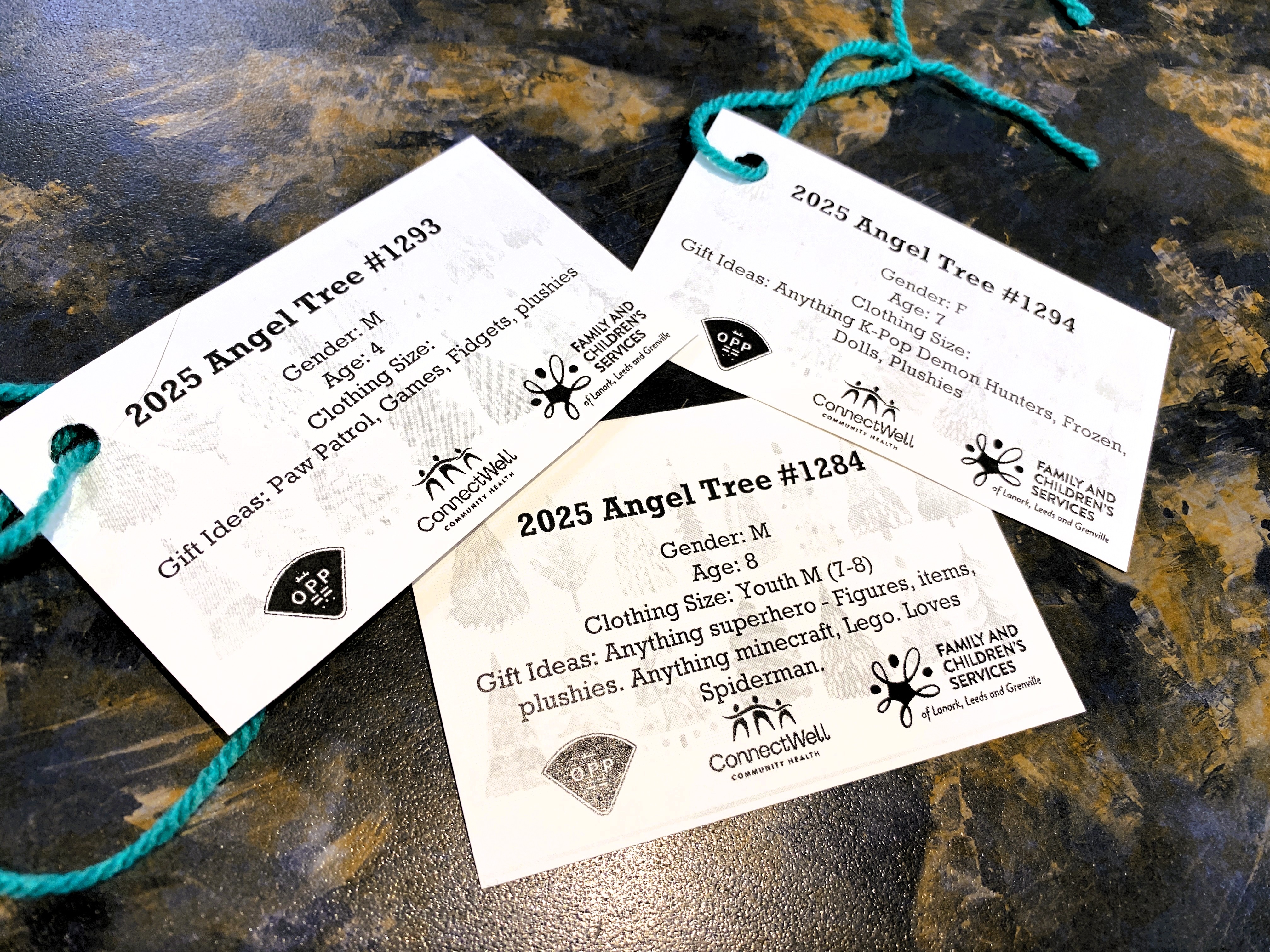 Photo of three Angel Tree tags laying on a countertop