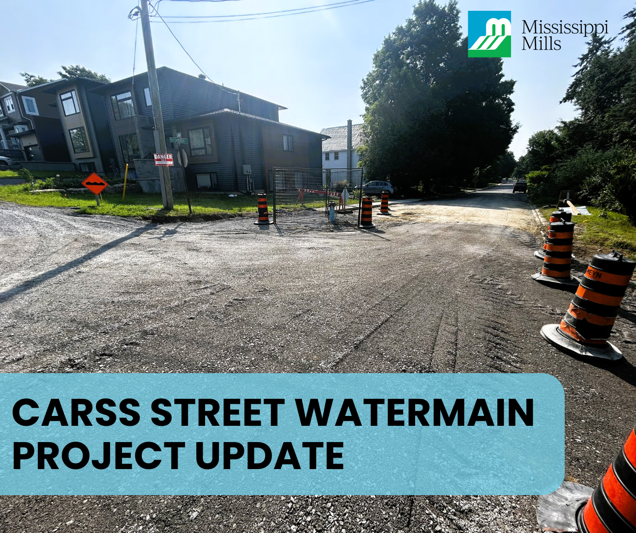 Photo of gravel intersection with black and orange traffic cones and the text 'Carss Street Watermain Project Update'
